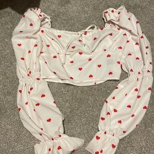 Long sleeve crop with red hearts.
